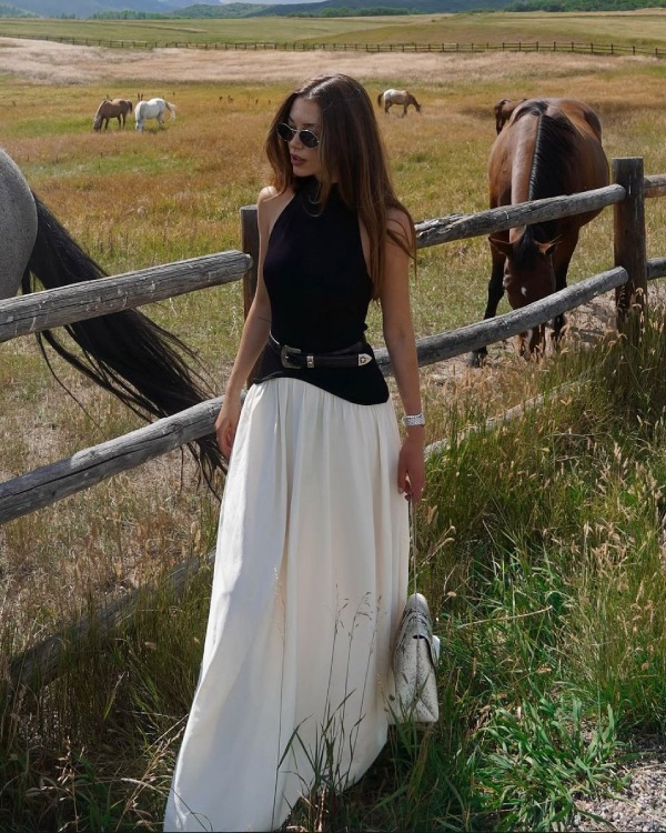 Long white skirt with elegant top and sunglasses.
