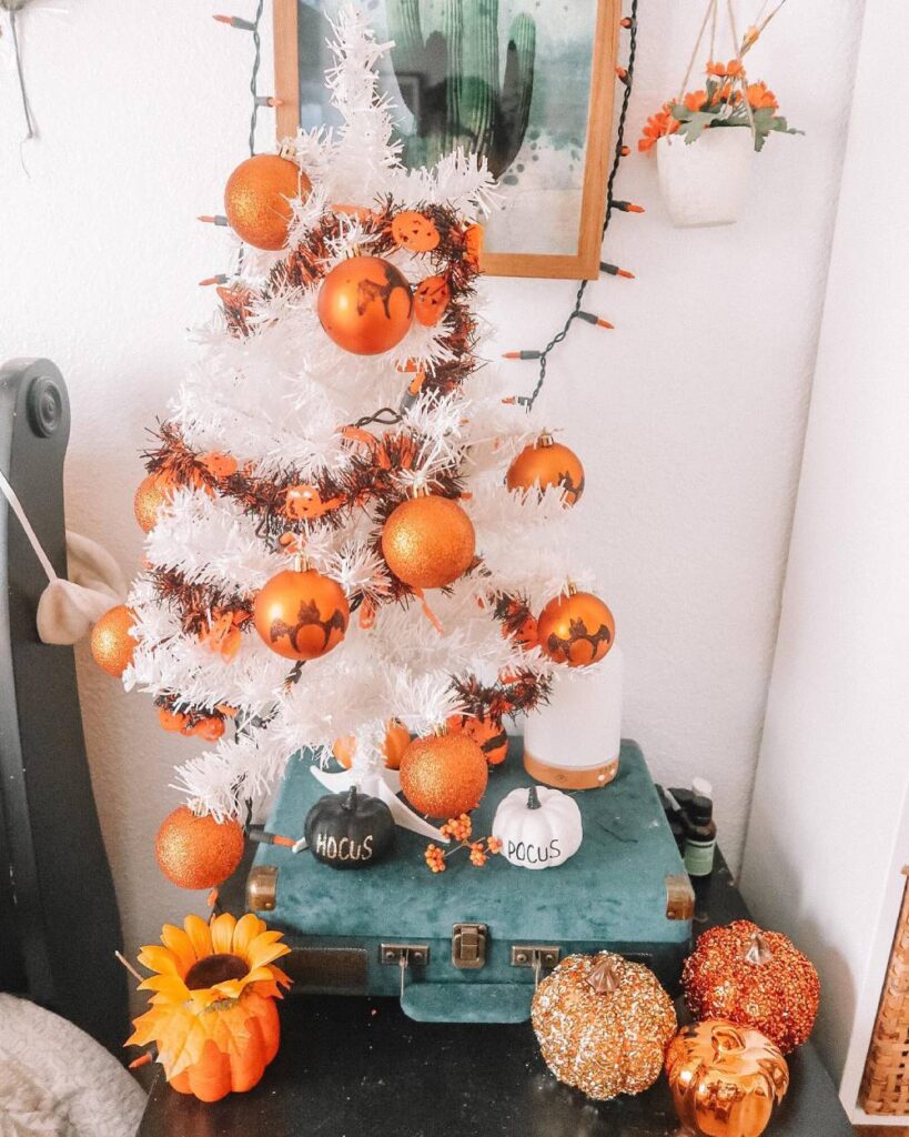 Halloween Tree With Orange ornaments and a white tree