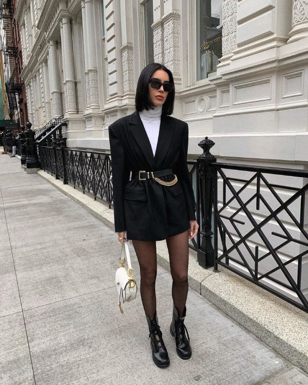 An oversized blazer tops a short dress paired with ankle boots, creating a playful yet powerful look. The streetwear-meets-sophistication vibe is pure NYC.