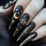 Black with gold celestial symbols serpents moons all seeing eyes Fun Witchy Nail Designs for Halloween